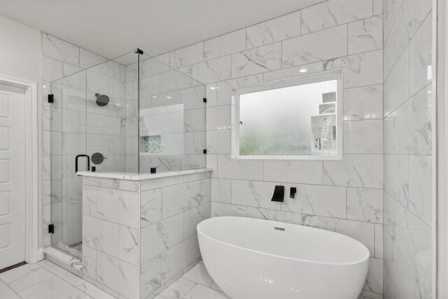 bathroom featuring tile walls and plus walk in shower