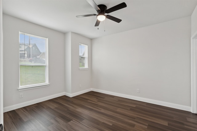 spare room with dark wood-type flooring and ceiling fan