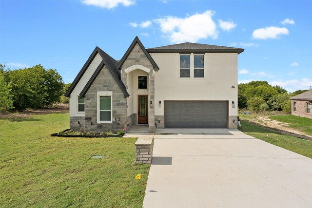 view of front of property featuring a garage and a front yard