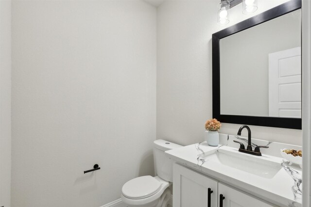 bathroom with toilet and vanity