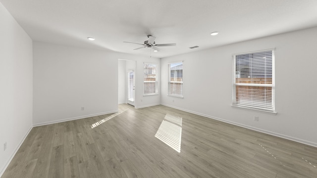 empty room featuring ceiling fan and light hardwood / wood-style flooring