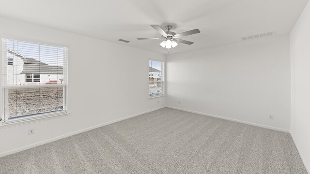 unfurnished bedroom featuring ensuite bathroom, light carpet, and ceiling fan