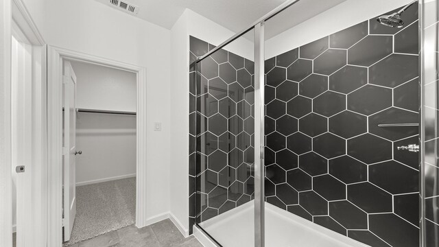 bathroom with ceiling fan, vanity, tile patterned flooring, and a shower