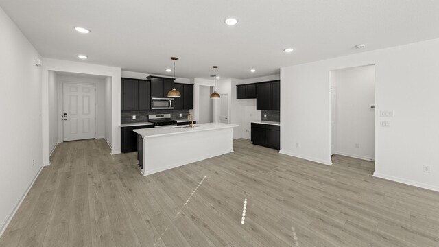 unfurnished living room with ceiling fan and light wood-type flooring