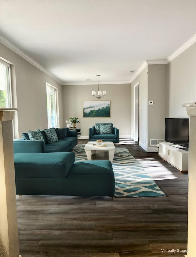 living room with dark hardwood / wood-style flooring, an inviting chandelier, and ornamental molding