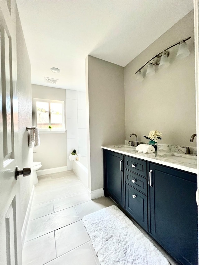 bathroom with tile patterned floors, vanity, and toilet