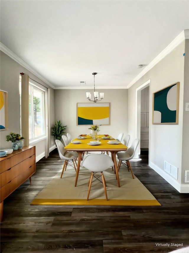 dining room featuring ornamental molding, dark wood-type flooring, and an inviting chandelier