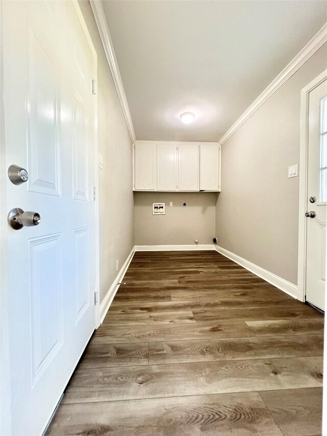 laundry room featuring crown molding, hookup for a washing machine, cabinets, and hardwood / wood-style flooring