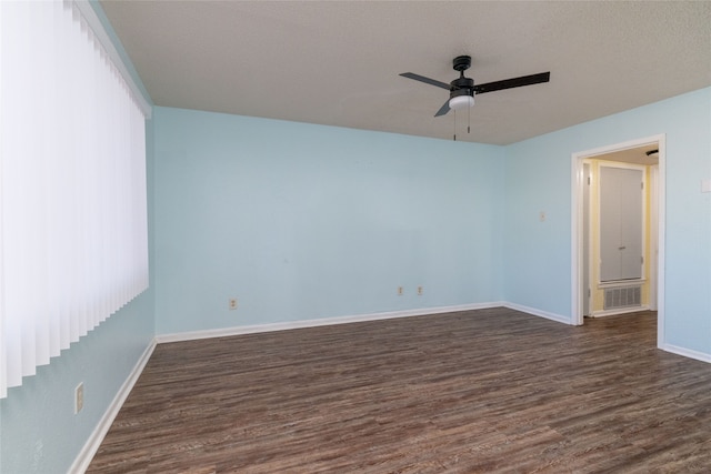 spare room featuring ceiling fan, dark hardwood / wood-style flooring, and a textured ceiling