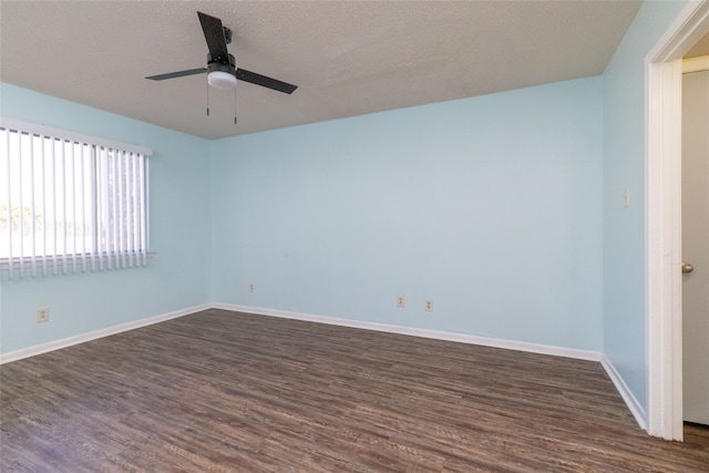 unfurnished room with a textured ceiling, dark wood-type flooring, and ceiling fan