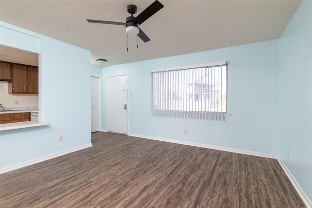 104 Harbor Dr Unit 111, Runaway Bay, TX 76426 - unfurnished living room with ceiling fan, dark wood-type flooring, a sink, and baseboards