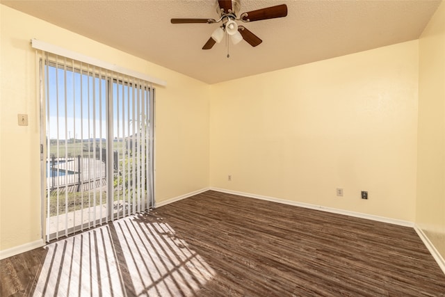 empty room with a textured ceiling, ceiling fan, and dark hardwood / wood-style flooring