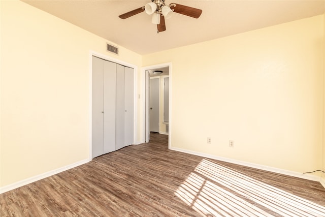 unfurnished bedroom with a closet, ceiling fan, and hardwood / wood-style flooring