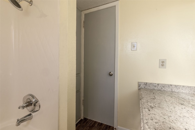 bathroom with hardwood / wood-style flooring