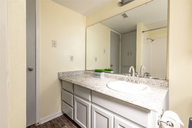 bathroom with hardwood / wood-style floors and vanity