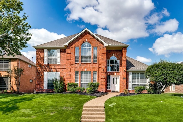 colonial-style house with a front lawn