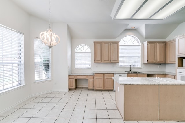 kitchen with lofted ceiling, plenty of natural light, sink, and light brown cabinets