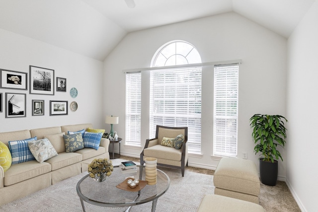 living room featuring lofted ceiling and light carpet