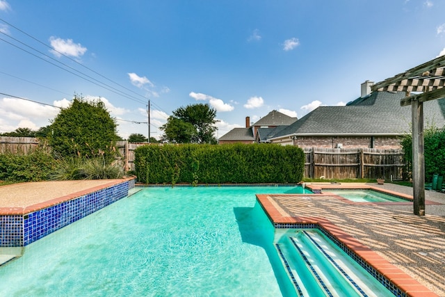 view of swimming pool featuring an in ground hot tub