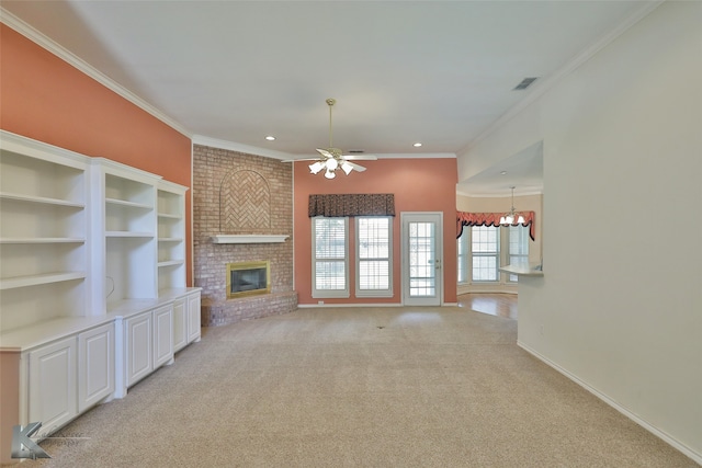 unfurnished living room featuring ceiling fan with notable chandelier, a fireplace, light carpet, and ornamental molding