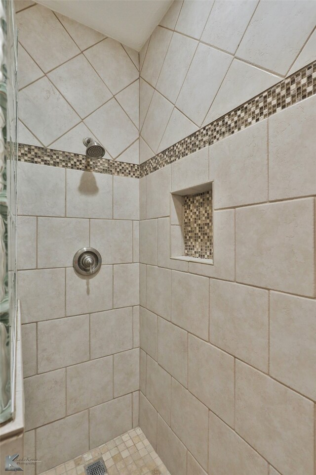 bathroom with tiled shower