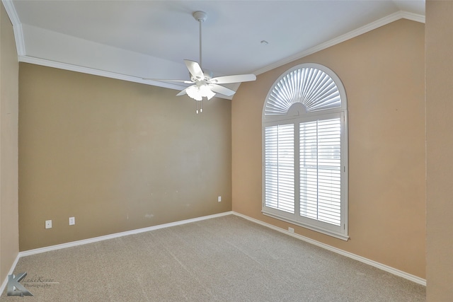 carpeted spare room with ornamental molding, vaulted ceiling, and ceiling fan