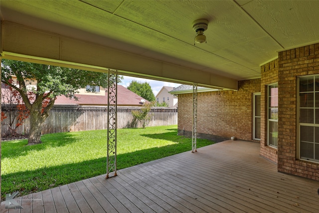 wooden terrace featuring a lawn