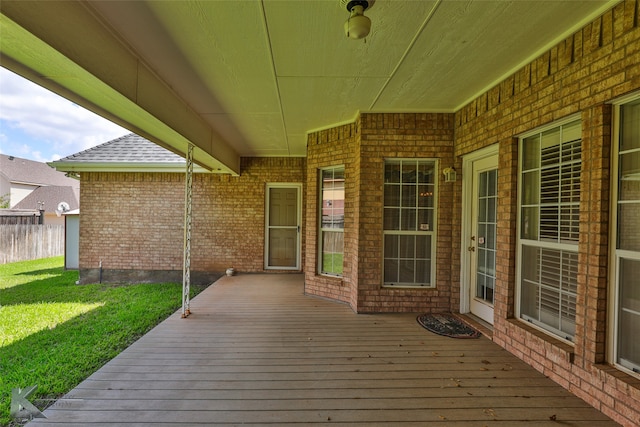 wooden deck with a lawn