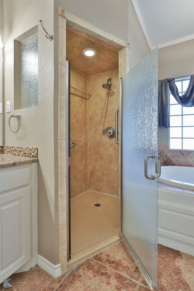 bathroom featuring vanity, tile patterned flooring, and shower with separate bathtub