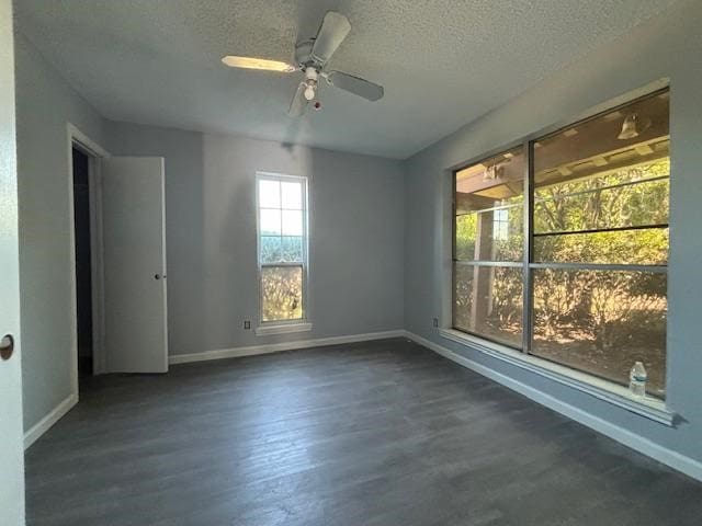 spare room featuring ceiling fan, dark hardwood / wood-style flooring, and a textured ceiling