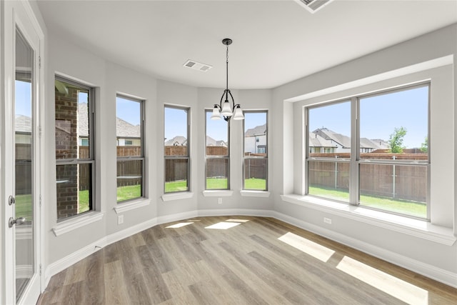 4100 Pond Cypress St, Aubrey, TX 76227 - unfurnished sunroom with visible vents, an inviting chandelier, wood finished floors, baseboards, and a wealth of natural light