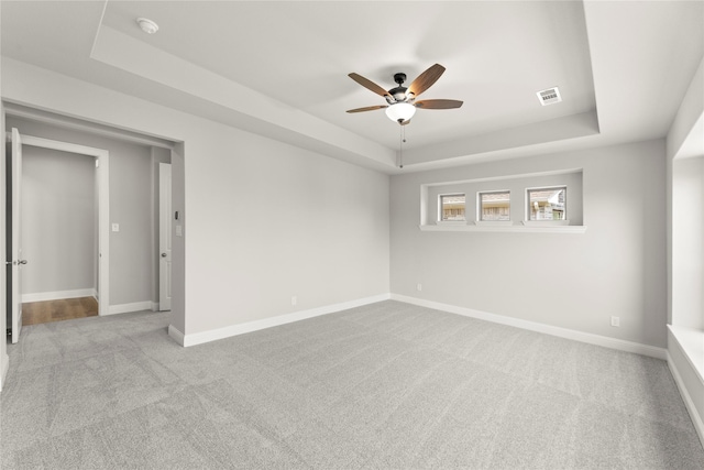 4100 Pond Cypress St, Aubrey, TX 76227 - carpeted spare room featuring visible vents, a ceiling fan, a raised ceiling, and baseboards