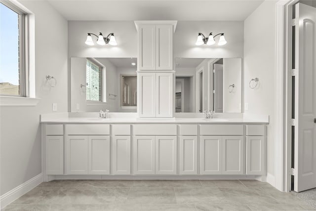 4100 Pond Cypress St, Aubrey, TX 76227 - bathroom with double vanity, baseboards, and a sink