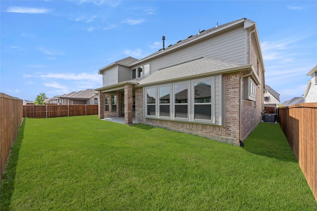 4100 Pond Cypress St, Aubrey, TX 76227 - back of house featuring a fenced backyard, a yard, and brick siding