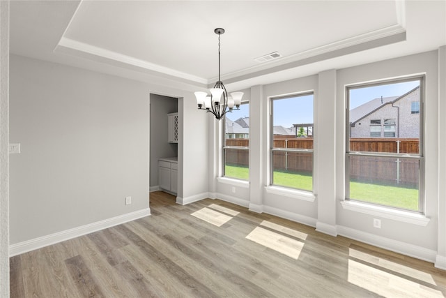 4100 Pond Cypress St, Aubrey, TX 76227 - unfurnished dining area with a raised ceiling, a notable chandelier, light wood-style flooring, and visible vents