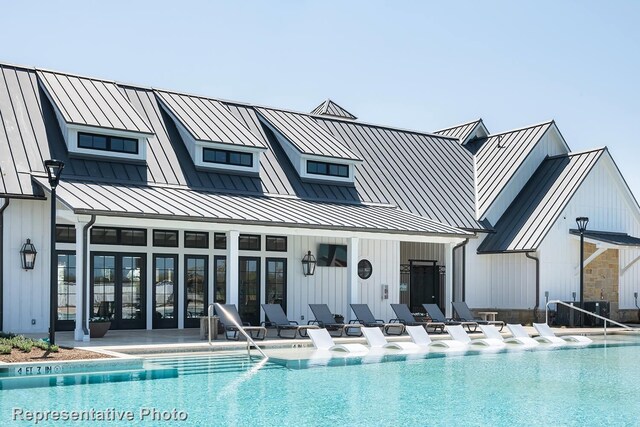 rear view of house with a community pool and a patio