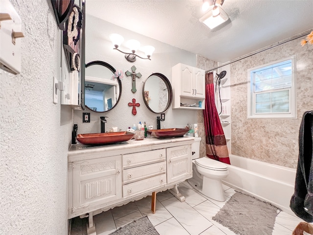 full bathroom with shower / bath combo with shower curtain, vanity, a textured ceiling, and toilet