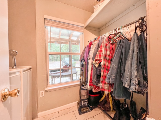 spacious closet with light tile patterned flooring