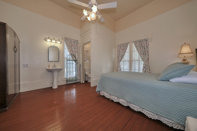 bedroom with ceiling fan, dark hardwood / wood-style floors, and vaulted ceiling