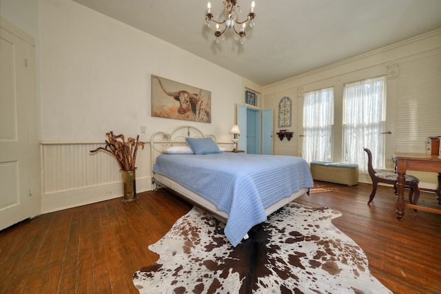 bedroom featuring dark wood-type flooring and a chandelier