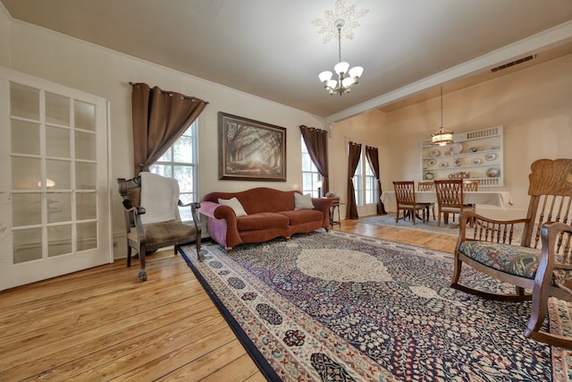 living room with a chandelier and light hardwood / wood-style floors