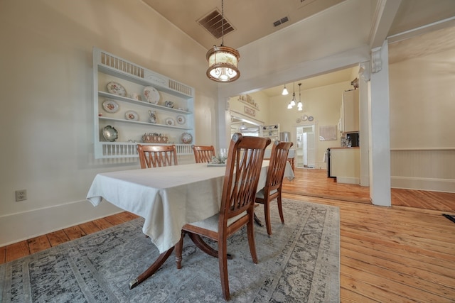 dining area with an inviting chandelier and light wood-type flooring