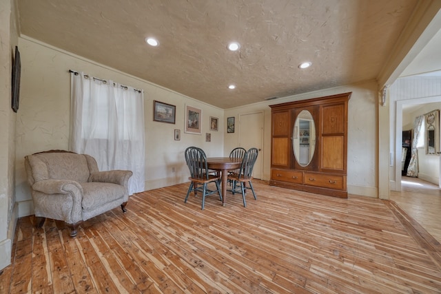 dining room with a textured ceiling and hardwood / wood-style flooring