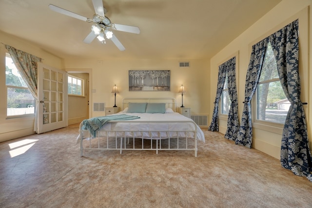 bedroom with ceiling fan and light carpet