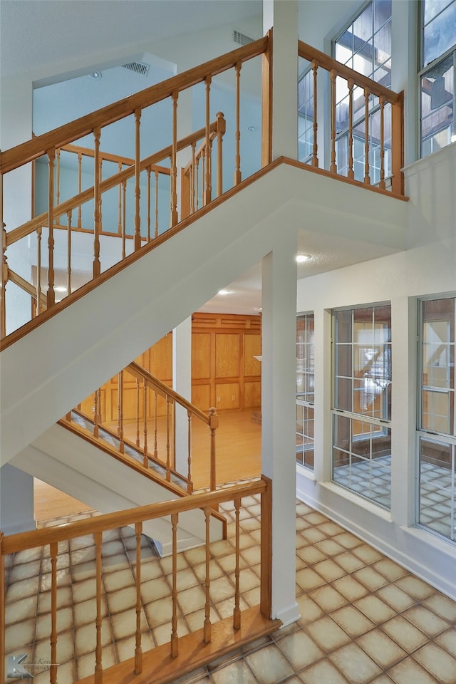 stairway featuring high vaulted ceiling