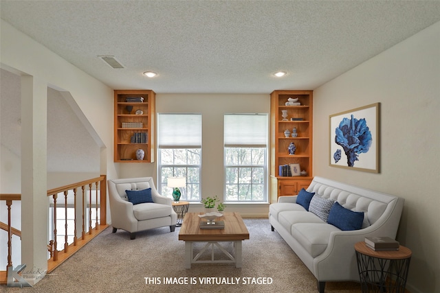 carpeted living room featuring a textured ceiling