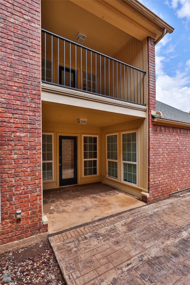 doorway to property featuring a patio area and a balcony