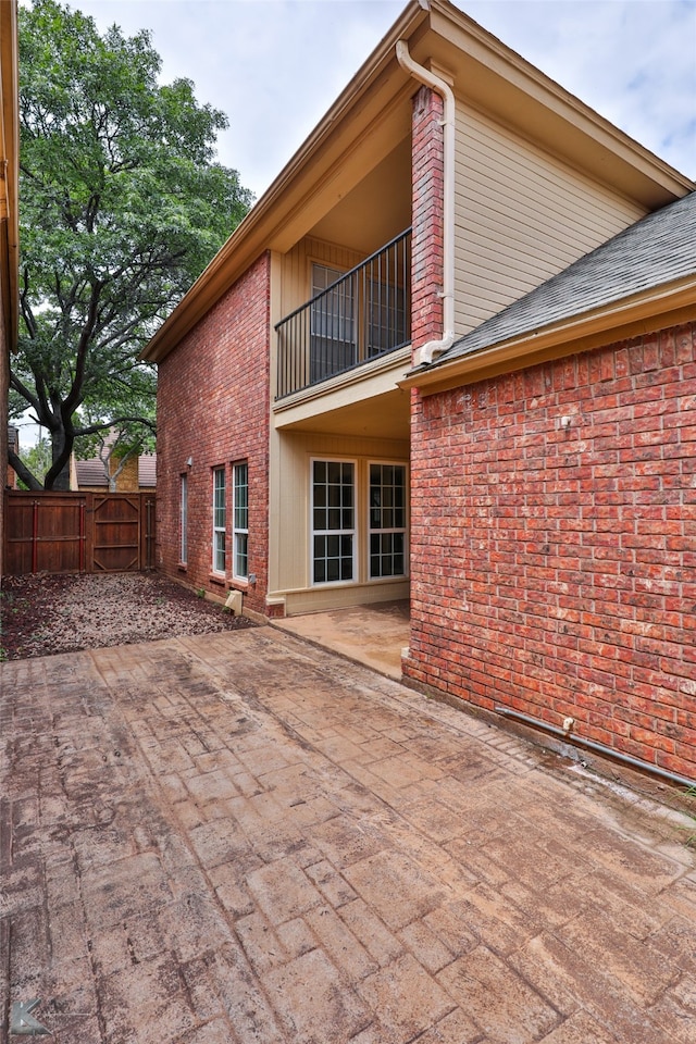 exterior space with a patio and a balcony