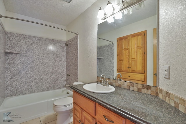 full bathroom featuring toilet, tile patterned flooring, tiled shower / bath combo, vanity, and a textured ceiling