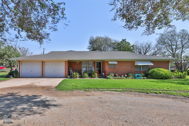 ranch-style home with a front lawn and a garage